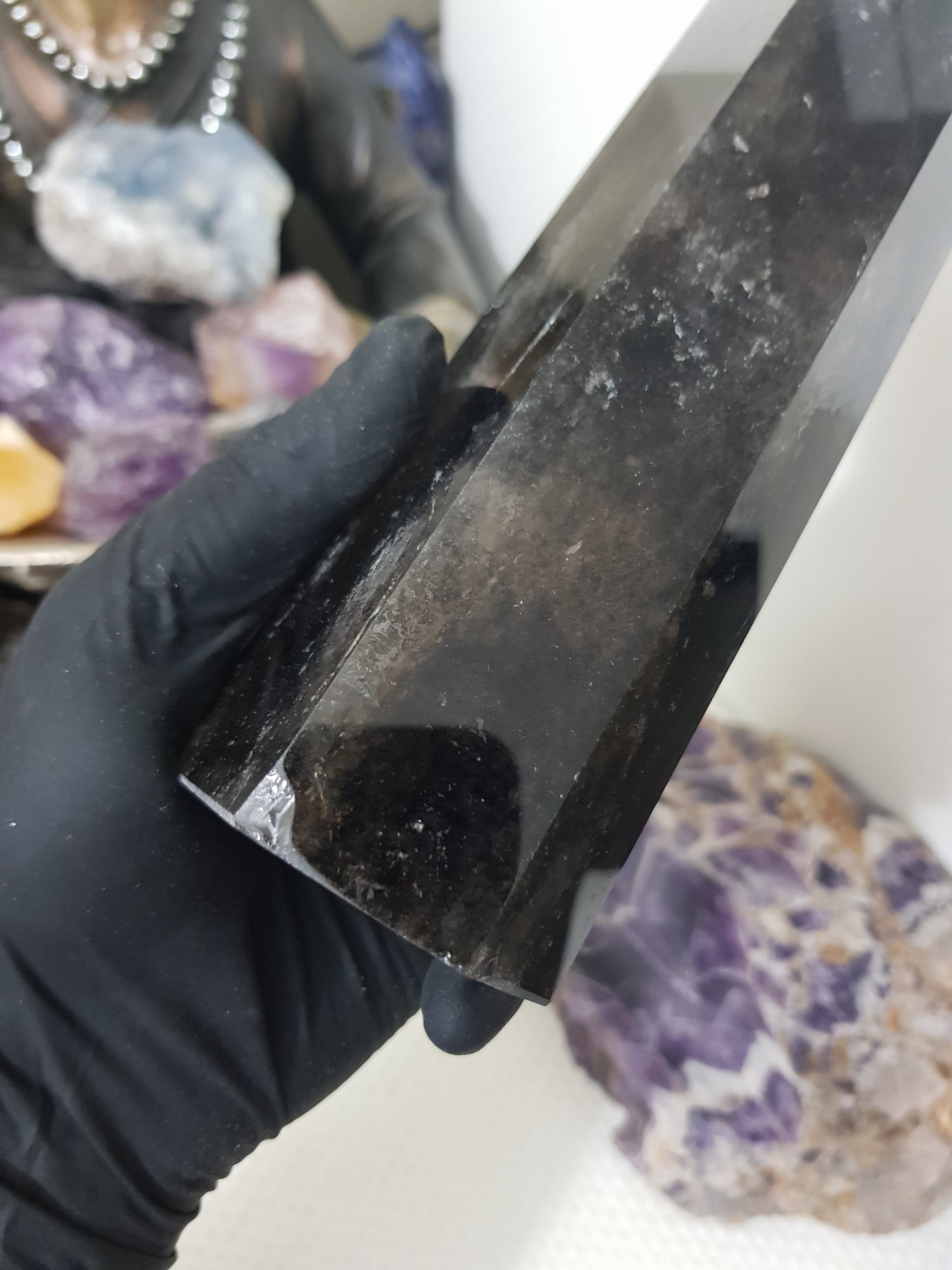 Hand holding a Smoky Quartz crystal point tower polished Brazil smoky brown point 20.5cm