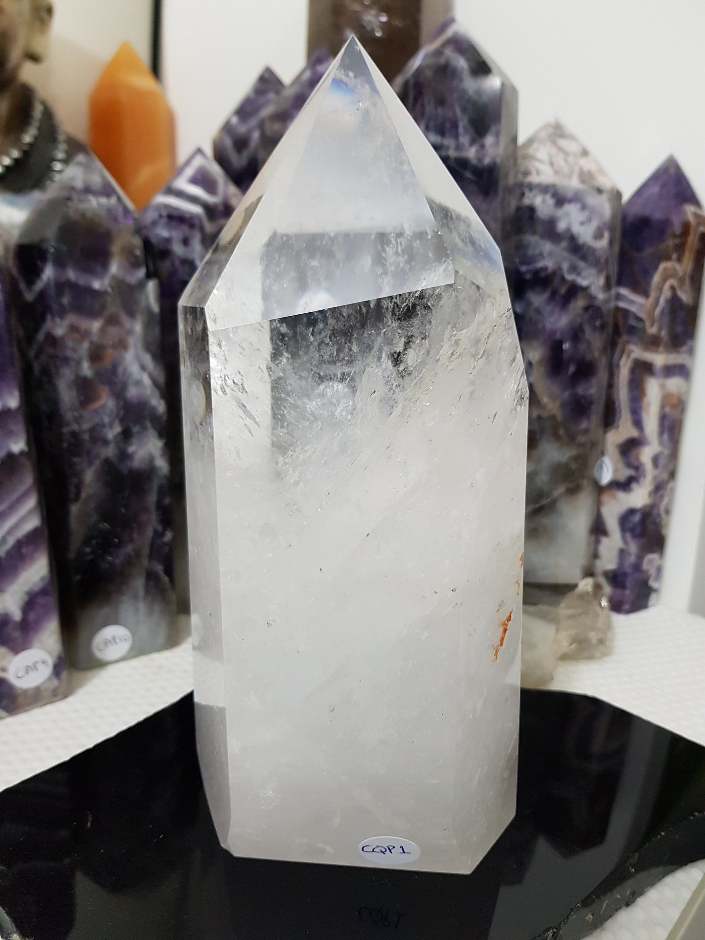 Clear Quartz crystal point tower polished standing specimen from Brazil with clear upper section and milky white base