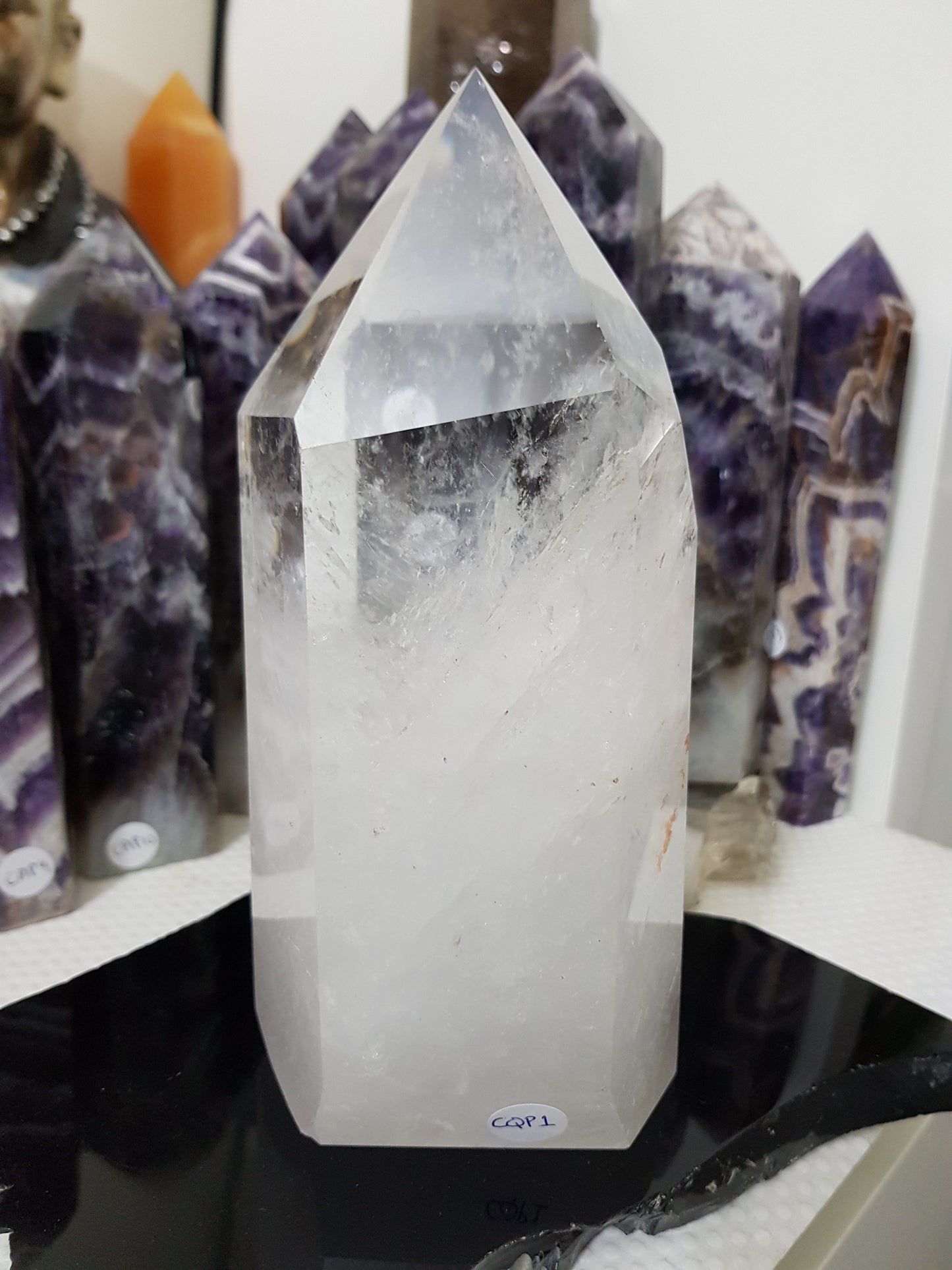 Clear Quartz crystal point tower polished standing specimen from Brazil with clear upper section and milky white base