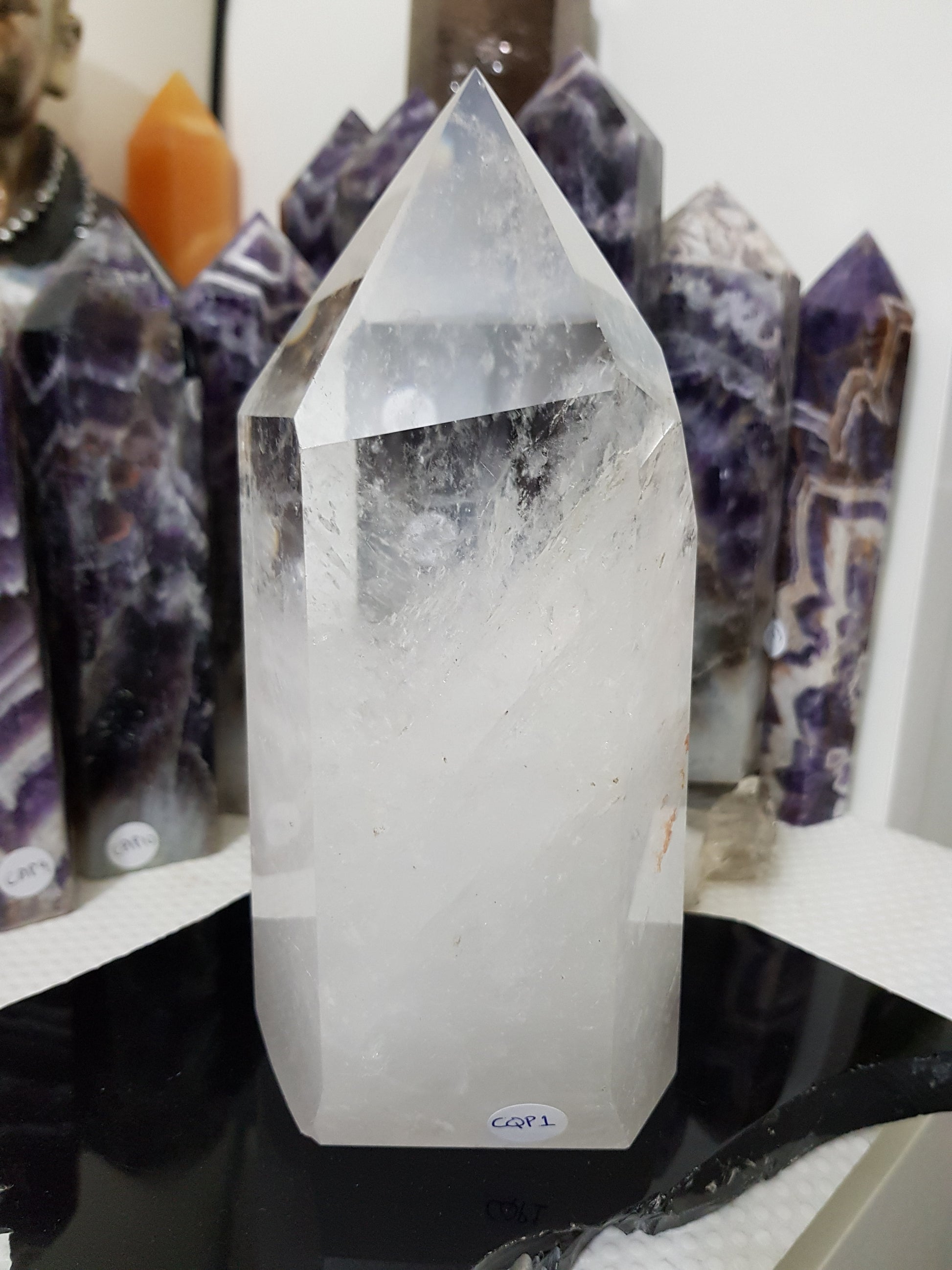 Clear Quartz crystal point tower polished standing specimen from Brazil with clear upper section and milky white base